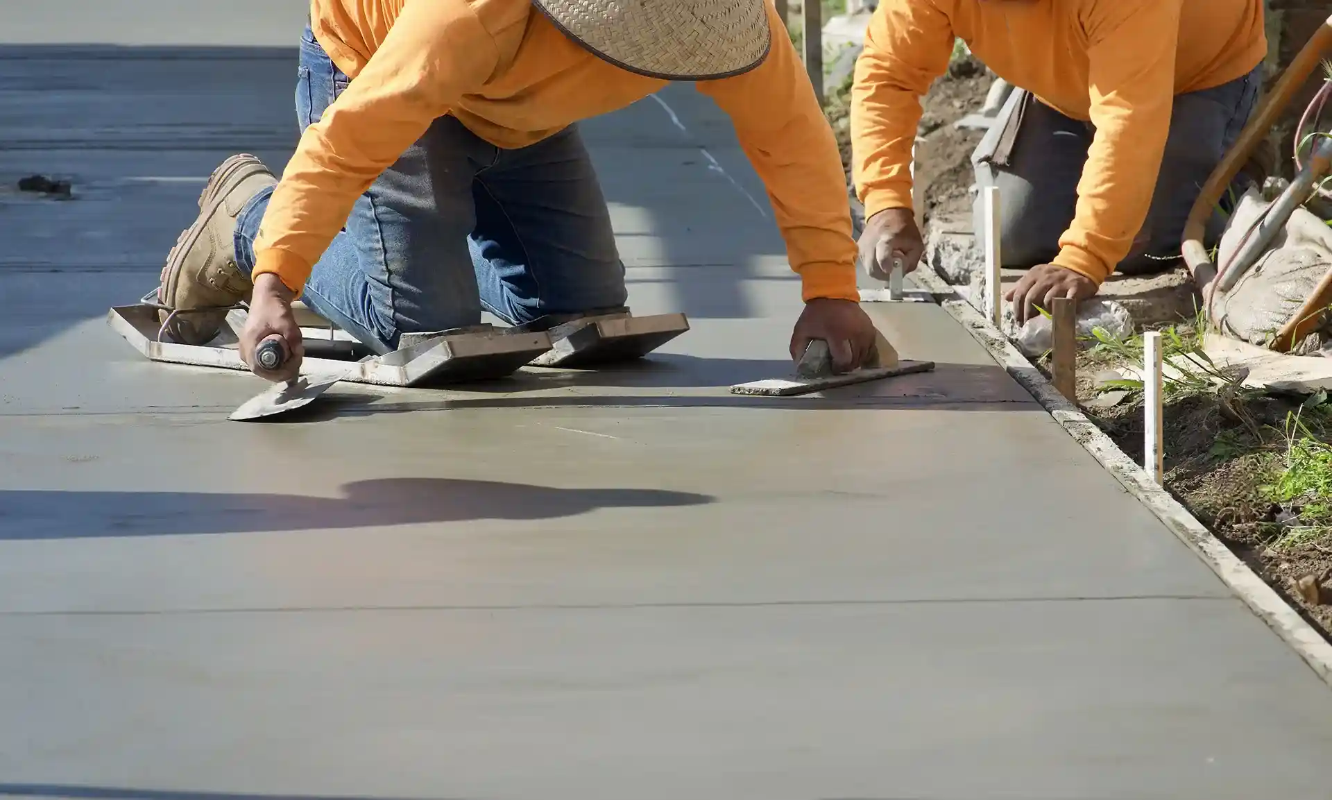 two men smoothing out concrete